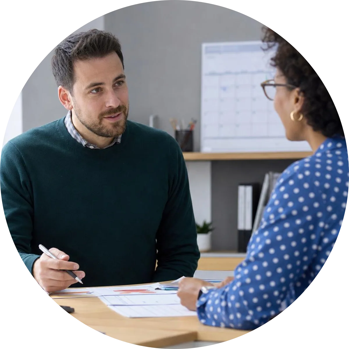 A learner discussing a certificate and calendar with a training adviser