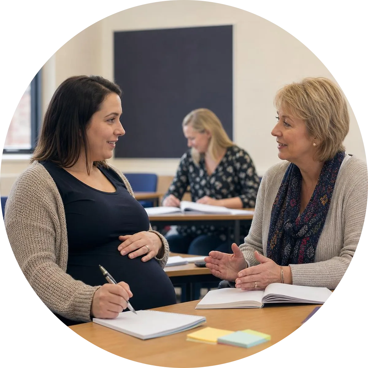 A pregnant learner seated comfortably and talking with a course instructor