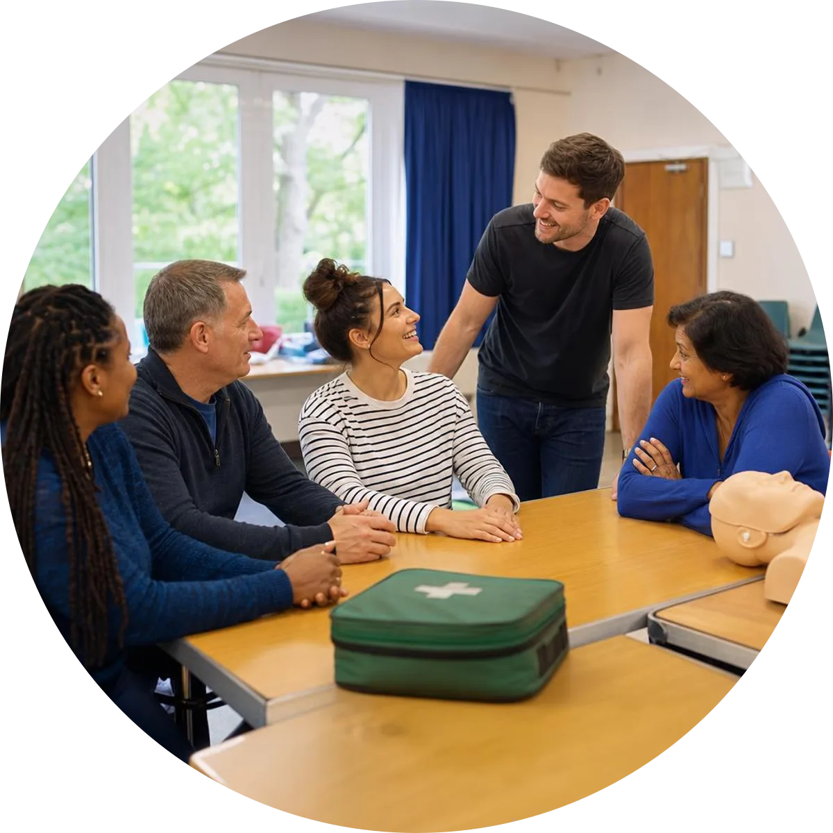 Community volunteers discussing training around an unused CPR manikin