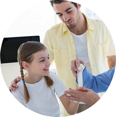 Adult caring for a child's bandaged arm